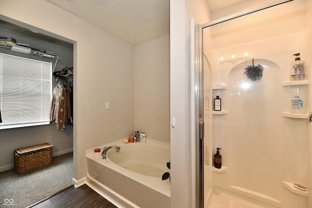 7604 Cloudy Ct, Camby, IN 46113 - bathroom featuring a stall shower, a garden tub, baseboards, and wood finished floors