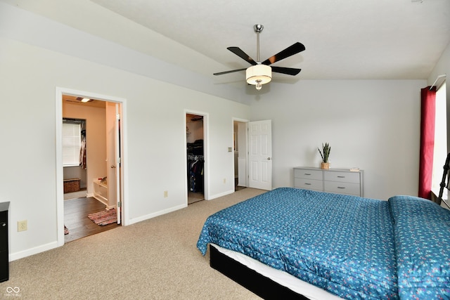 7604 Cloudy Ct, Camby, IN 46113 - carpeted bedroom with baseboards, a walk in closet, ceiling fan, lofted ceiling, and ensuite bathroom