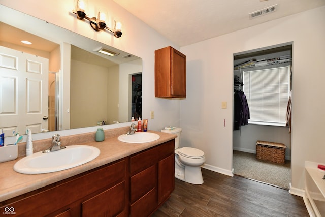 7604 Cloudy Ct, Camby, IN 46113 - bathroom featuring a spacious closet, a shower stall, double vanity, and wood finished floors