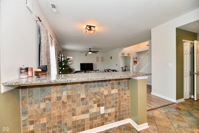 7604 Cloudy Ct, Camby, IN 46113 - kitchen with ceiling fan, stone finish flooring, open floor plan, baseboards, and light stone countertops