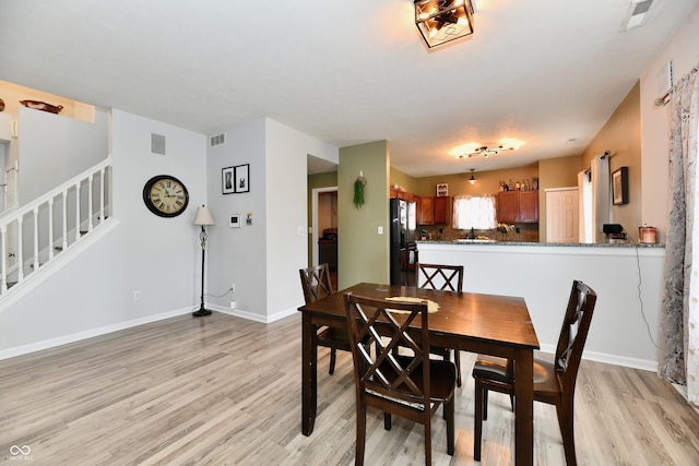7604 Cloudy Ct, Camby, IN 46113 - dining space with light wood-type flooring, stairway, and baseboards