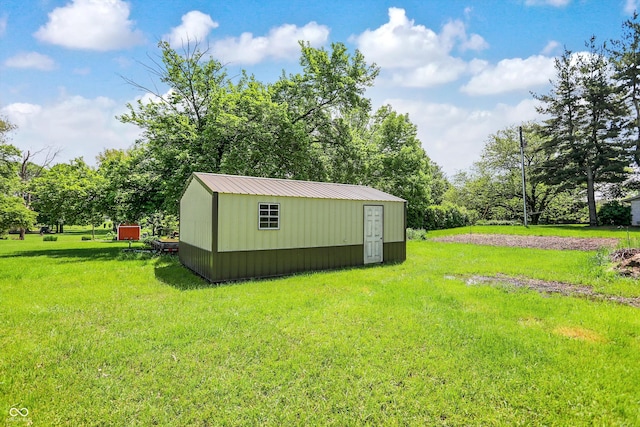 view of grassy yard featuring an outbuilding and a shed