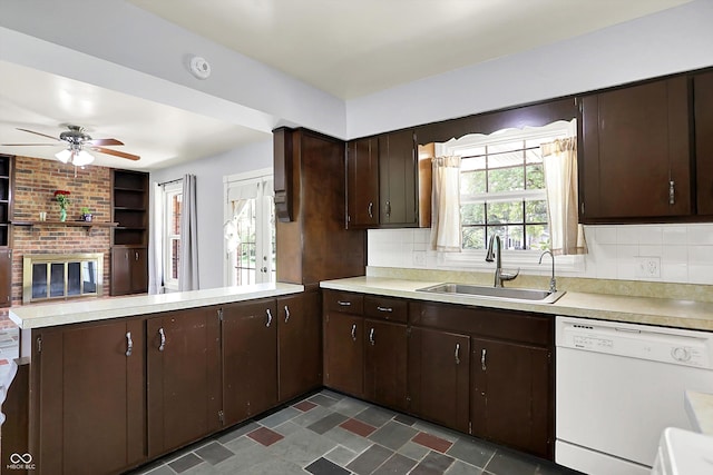 kitchen featuring white dishwasher, a sink, light countertops, a peninsula, and dark brown cabinetry