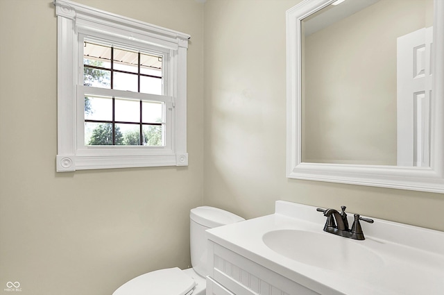 bathroom featuring toilet and vanity