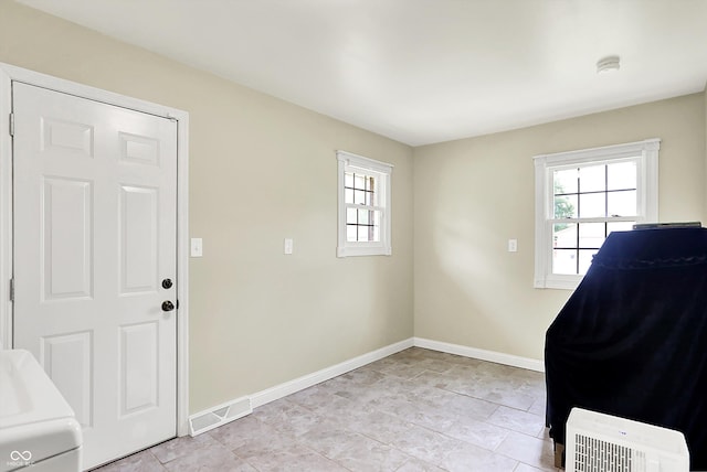 entryway with baseboards and light tile patterned floors