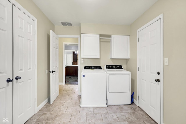 laundry area featuring cabinet space, independent washer and dryer, and baseboards