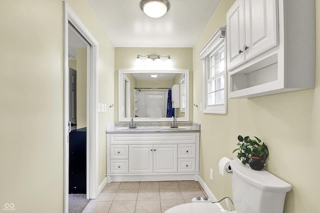 full bath featuring toilet, baseboards, tile patterned flooring, and double vanity