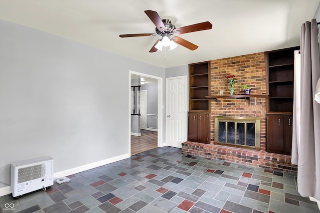 unfurnished living room featuring built in features, heating unit, a ceiling fan, and baseboards