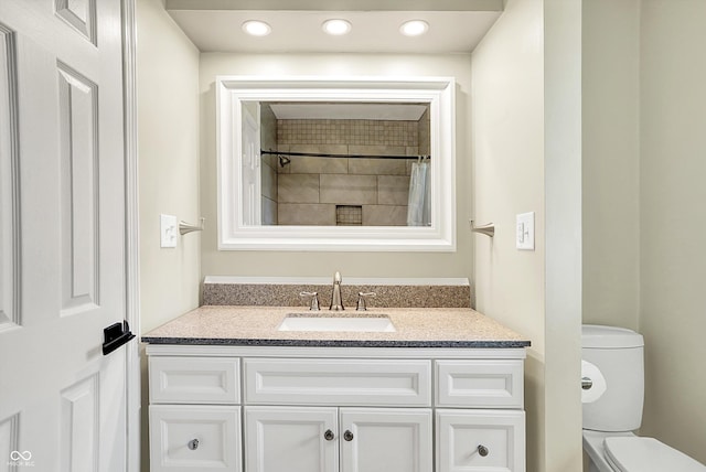 full bathroom with toilet and vanity