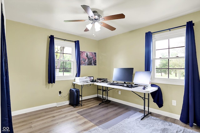 office featuring wood finished floors, a ceiling fan, and baseboards