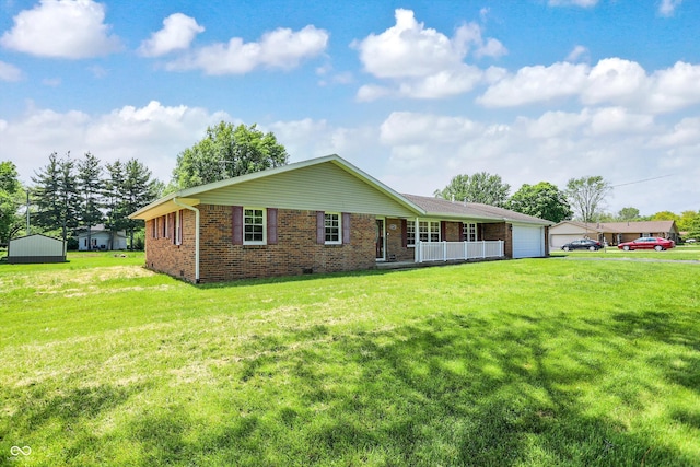 view of front of property with brick siding, a front yard, a garage, and a porch