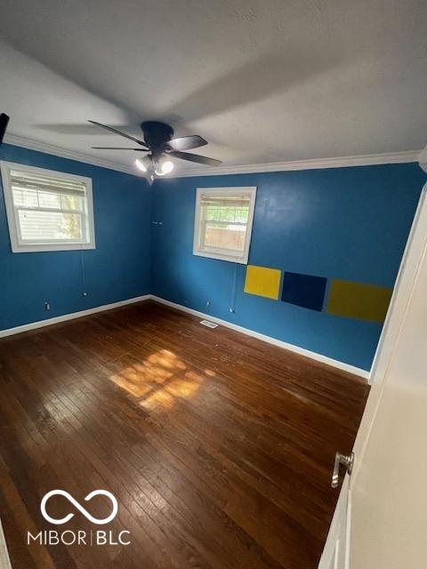 5802 Bertha St, Indianapolis, IN 46241 - spare room featuring crown molding, hardwood / wood-style flooring, baseboards, and ceiling fan