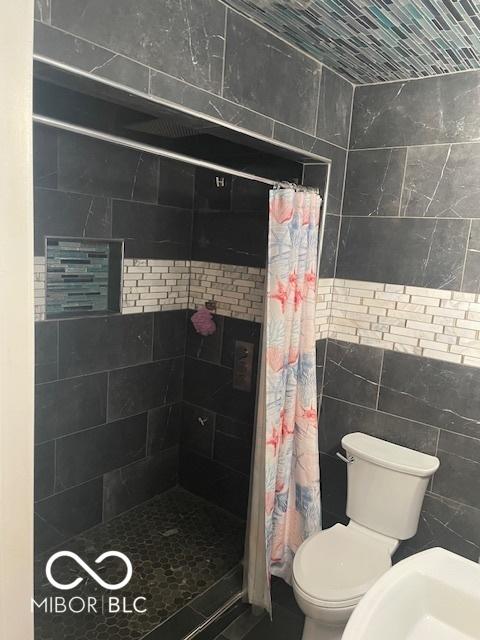 5802 Bertha St, Indianapolis, IN 46241 - full bathroom with a shower stall and toilet