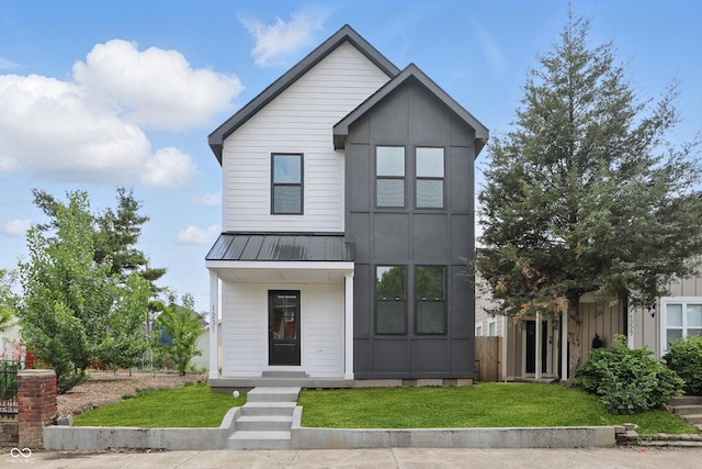 1231 Marlowe Ave, Indianapolis, IN 46202 - view of front of property with a front lawn, a metal roof, and a standing seam roof