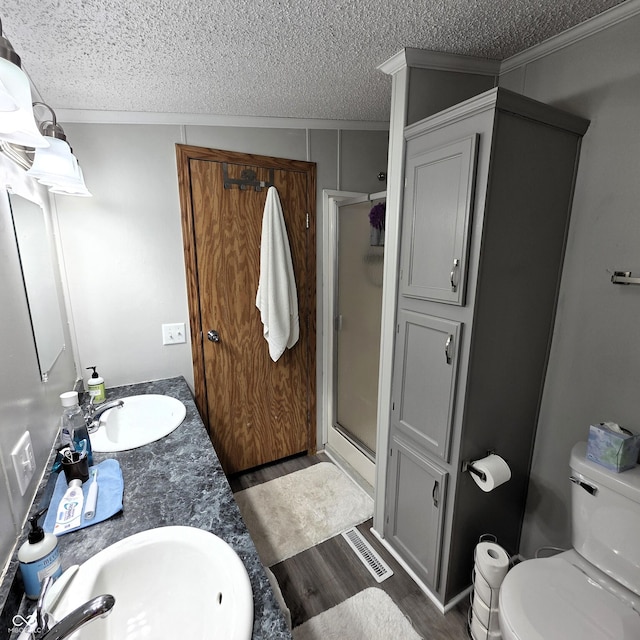 5269 W State Road 42, Brazil, IN 47834 - bathroom with a textured ceiling, a shower stall, wood finished floors, toilet, and crown molding