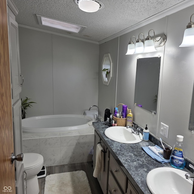 5269 W State Road 42, Brazil, IN 47834 - bathroom with wood finished floors, a textured ceiling, a relaxing tiled tub, double vanity, and toilet