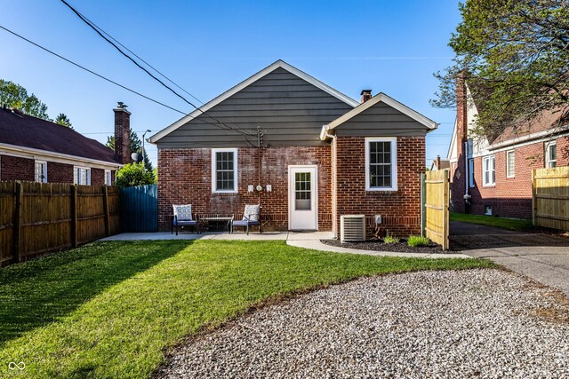 5428 E 10th St, Indianapolis, IN 46219 - rear view of house with brick siding, central AC unit, and a patio area