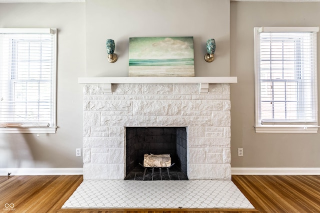 5428 E 10th St, Indianapolis, IN 46219 - detailed view of wood finished floors, baseboards, and a fireplace with flush hearth