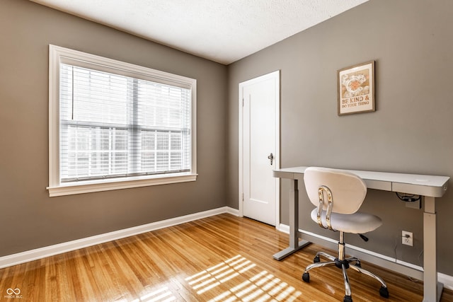 5428 E 10th St, Indianapolis, IN 46219 - home office with baseboards, wood finished floors, and a textured ceiling