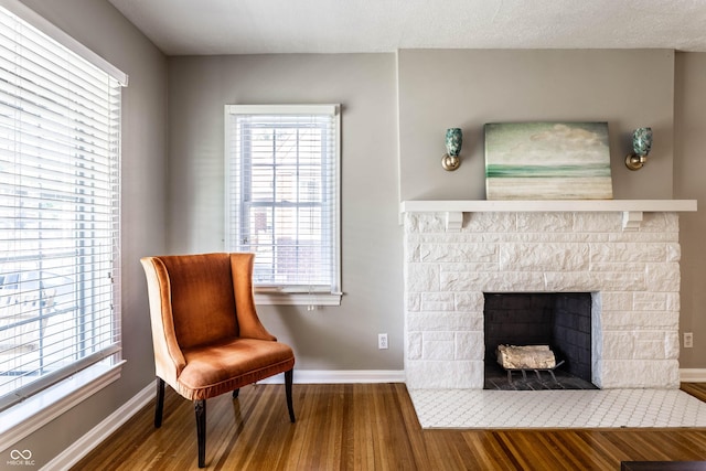 5428 E 10th St, Indianapolis, IN 46219 - living area with wood finished floors, baseboards, and healthy amount of natural light