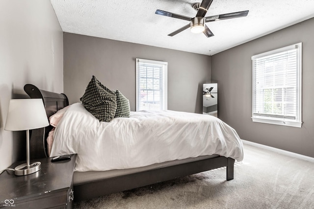 5428 E 10th St, Indianapolis, IN 46219 - bedroom with baseboards, carpet floors, ceiling fan, and a textured ceiling