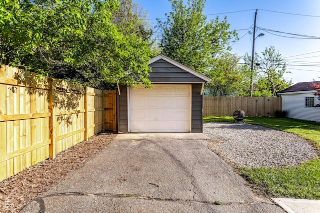 5428 E 10th St, Indianapolis, IN 46219 - detached garage featuring asphalt driveway and fence