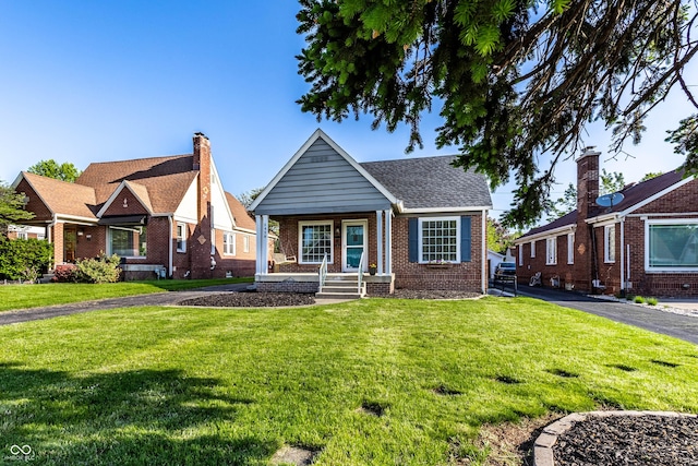 5428 E 10th St, Indianapolis, IN 46219 - view of front of property featuring brick siding, a front yard, and a porch