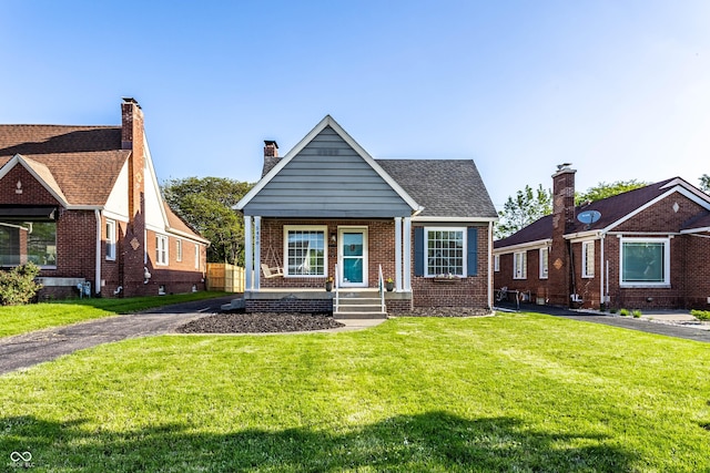 5428 E 10th St, Indianapolis, IN 46219 - view of front of property featuring a front lawn and brick siding