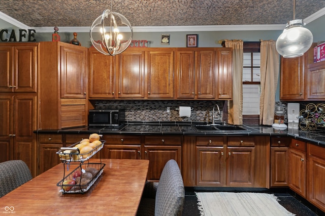 2134 N Alabama St, Indianapolis, IN 46202 - kitchen with a sink, stainless steel microwave, backsplash, crown molding, and brown cabinets