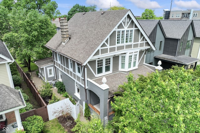 2134 N Alabama St, Indianapolis, IN 46202 - back of house featuring a shingled roof, fence, a chimney, and stucco siding