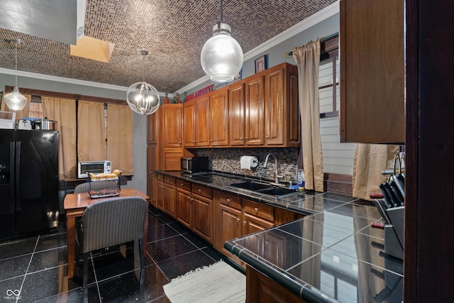 2134 N Alabama St, Indianapolis, IN 46202 - kitchen with black fridge with ice dispenser, ornamental molding, a sink, brown cabinets, and hanging light fixtures