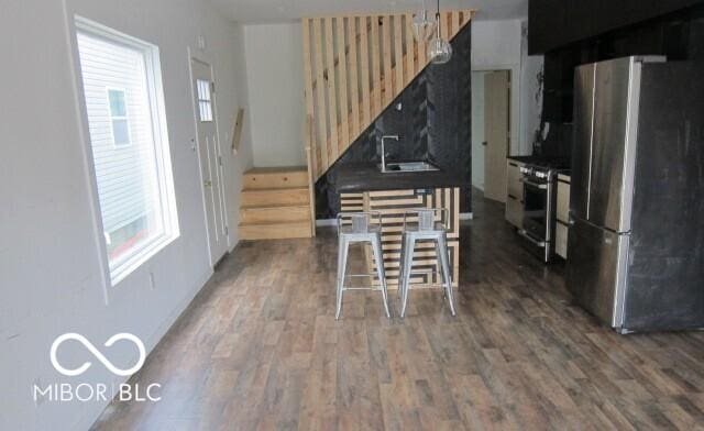 kitchen featuring stainless steel appliances, wood finished floors, and a sink