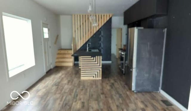 living room with wood finished floors and stairway