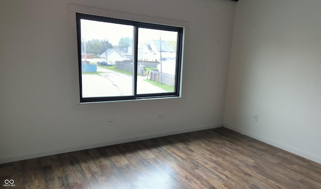 empty room with wood finished floors and baseboards
