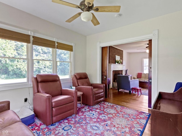 19702 Centennial Rd, Sheridan, IN 46069 - living area featuring ceiling fan, wood finished floors, and a brick fireplace