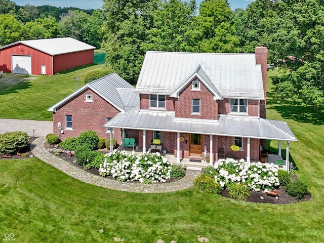 19702 Centennial Rd, Sheridan, IN 46069 - view of front facade featuring brick siding, a standing seam roof, a chimney, a front yard, and a detached garage