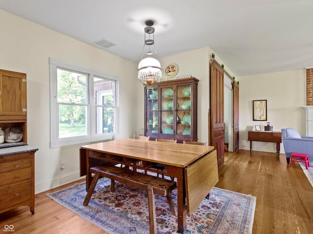 19702 Centennial Rd, Sheridan, IN 46069 - dining space with a barn door and light wood finished floors
