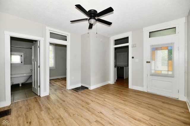 631 Prospect St, Indianapolis, IN 46203 - unfurnished bedroom featuring light wood-style flooring, ensuite bath, and a ceiling fan
