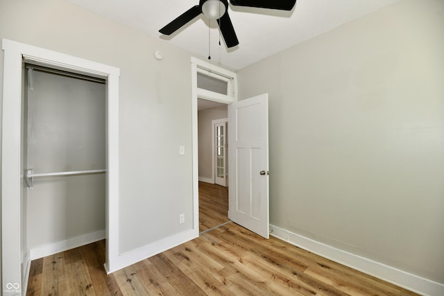 631 Prospect St, Indianapolis, IN 46203 - unfurnished bedroom featuring light wood-style floors, a ceiling fan, and a closet