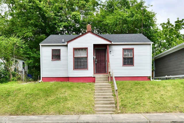 2966 N Olney St, Indianapolis, IN 46218 - bungalow-style home featuring a chimney, a front lawn, a shingled roof, and entry steps