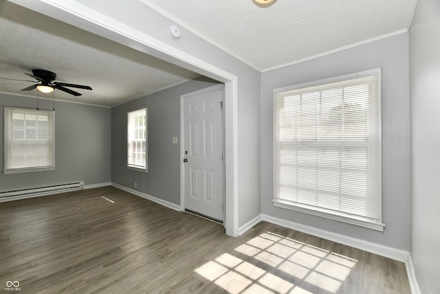 2966 N Olney St, Indianapolis, IN 46218 - entryway with a baseboard heating unit, wood finished floors, crown molding, baseboards, and a ceiling fan