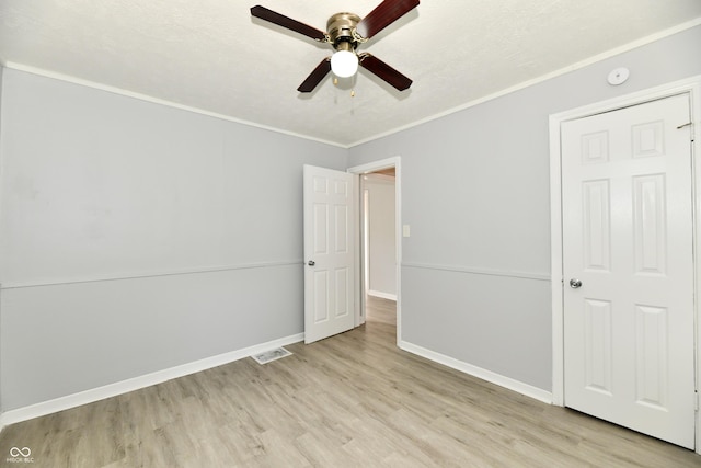 2966 N Olney St, Indianapolis, IN 46218 - unfurnished bedroom with wood finished floors, baseboards, ornamental molding, and a ceiling fan