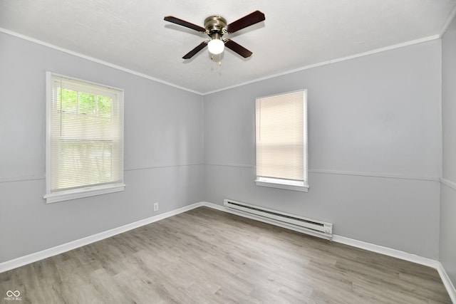 2966 N Olney St, Indianapolis, IN 46218 - spare room featuring baseboard heating, ornamental molding, a ceiling fan, wood finished floors, and baseboards
