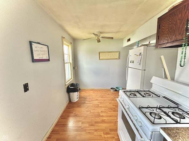 kitchen featuring white appliances, light wood-style floors, a ceiling fan, and baseboards