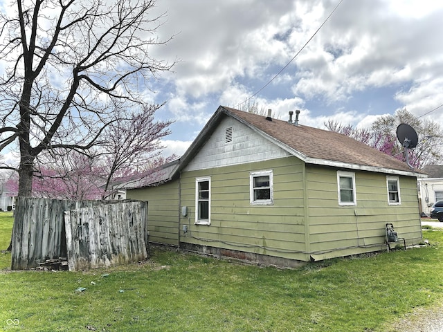rear view of property with a lawn