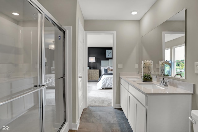 full bath featuring ensuite bath, a shower stall, double vanity, recessed lighting, and baseboards