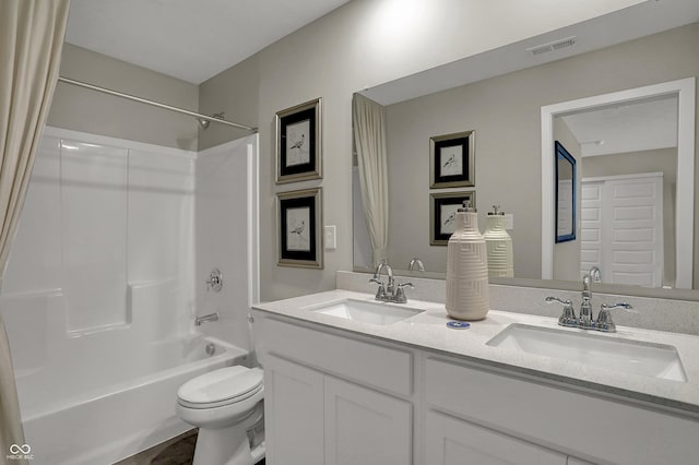 full bath featuring toilet, shower / bath combination, and double vanity