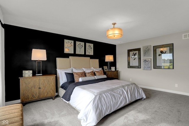 carpeted bedroom with baseboards and an accent wall