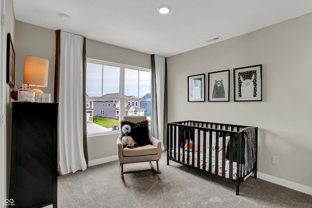 bedroom featuring carpet flooring, baseboards, and a nursery area