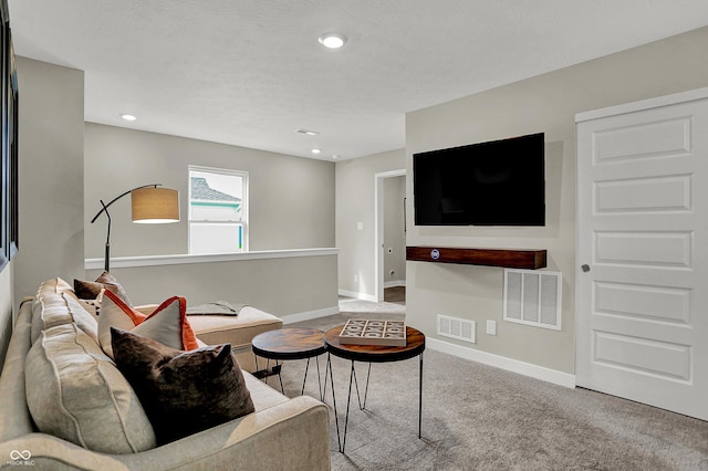 living room featuring carpet, baseboards, and recessed lighting